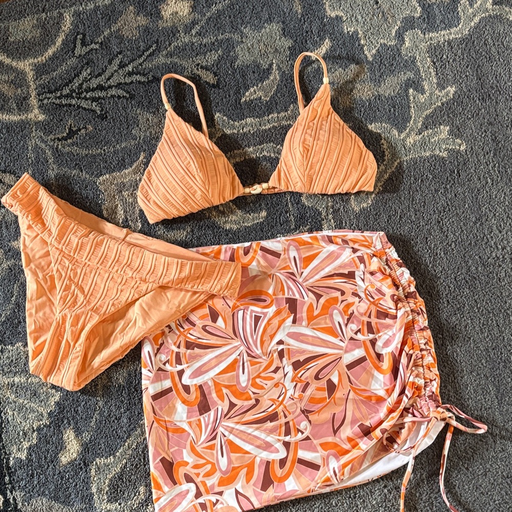 L*Space skirt coverup with a matching orange bikini swimsuit